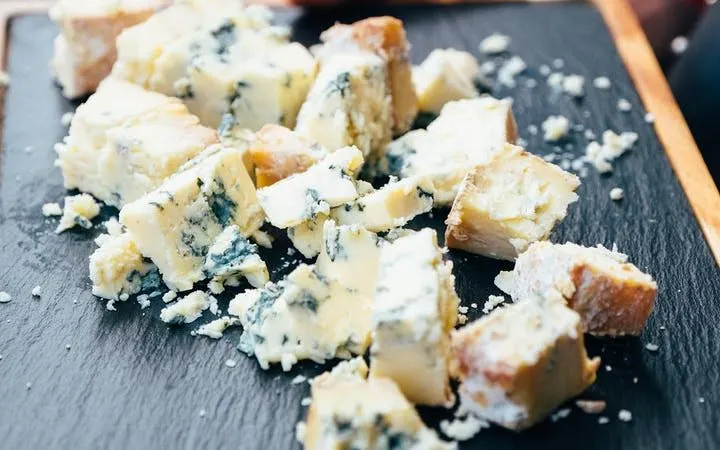 Cheese platter with blue cheese chunks on Edinburgh food tour.