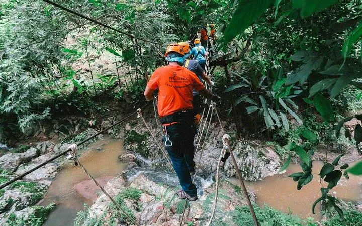 Participants crossing a rope bridge at Phoenix Zipline Adventure Park, Chiang Mai.
