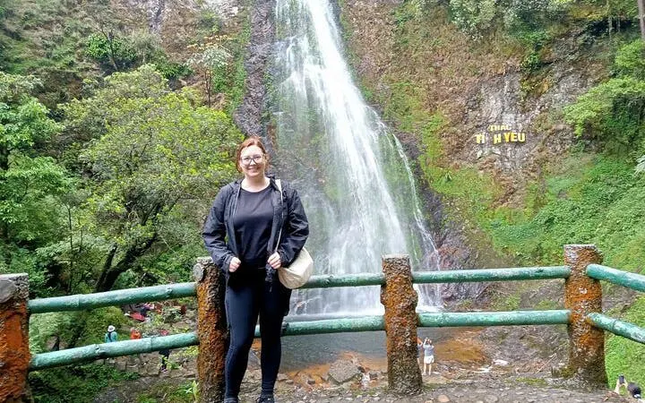 Visitor at Thac Tinh Yeu waterfall in Sapa, Vietnam, during a motorbike tour.