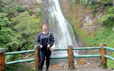 Visitor at Thac Tinh Yeu waterfall in Sapa, Vietnam, during a motorbike tour.