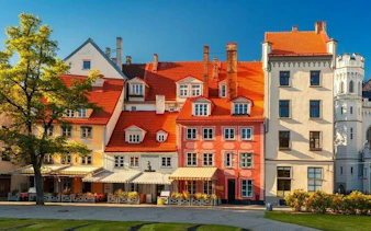 Colorful historic buildings in Riga's Old Town on a sunny day, part of a self-guided walking tour.