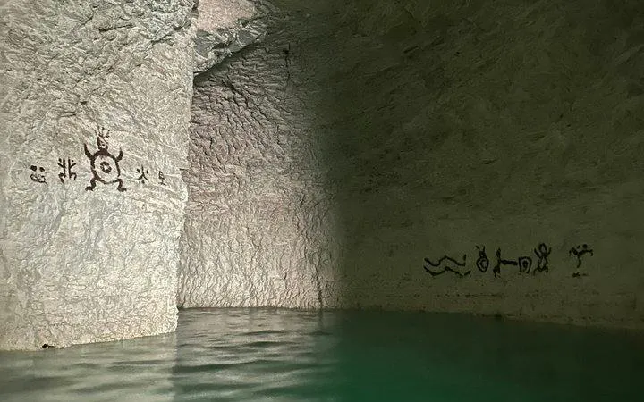 Subterranean river with ancient petroglyphs in Punta Cana hidden cenote.