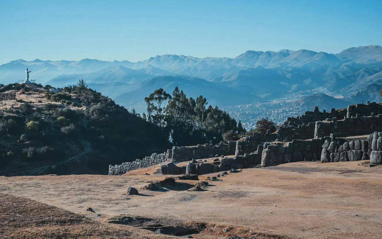 Sacsayhuamán ruins with Cristo Blanco statue overlooking Cusco, Peru.