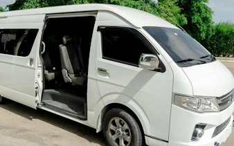 White tour van with open door for Santo Domingo guided tour, includes hotel transfers from Punta Cana.