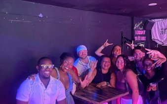 Group enjoying Sint Maarten party bus nightlife tour with bar stops and complimentary shots.