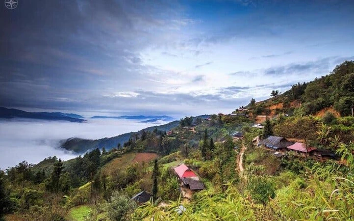Sapa landscape with misty mountains and village, part of motorbike tour to waterfall and Pusamcap Cave.