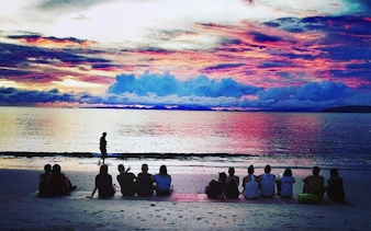 Small group watching sunset on Krabi beach during 4 Islands speedboat tour.