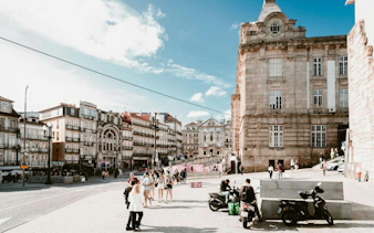 Porto Historic Center with people walking near historic buildings on a sunny day.