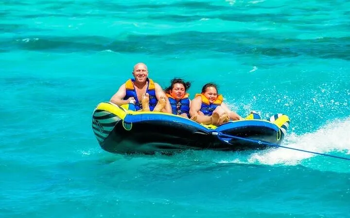People enjoying a banana boat ride on turquoise waters in Sharm El Sheikh.