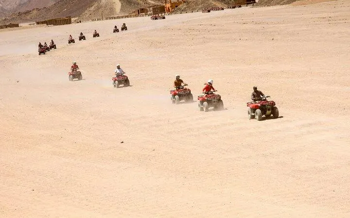 Quad ATV riders on desert safari in Sharm El Sheikh.