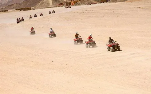 Quad ATV riders on desert safari in Sharm El Sheikh.