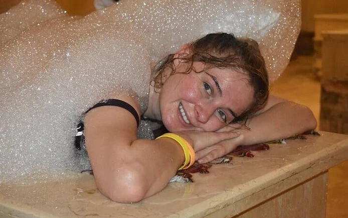 Guest enjoying a traditional Moroccan hammam with foam massage in a 16th-century Marrakesh bathhouse.