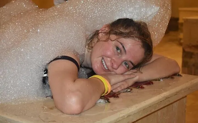 Guest enjoying a traditional Moroccan hammam with foam massage in a 16th-century Marrakesh bathhouse.