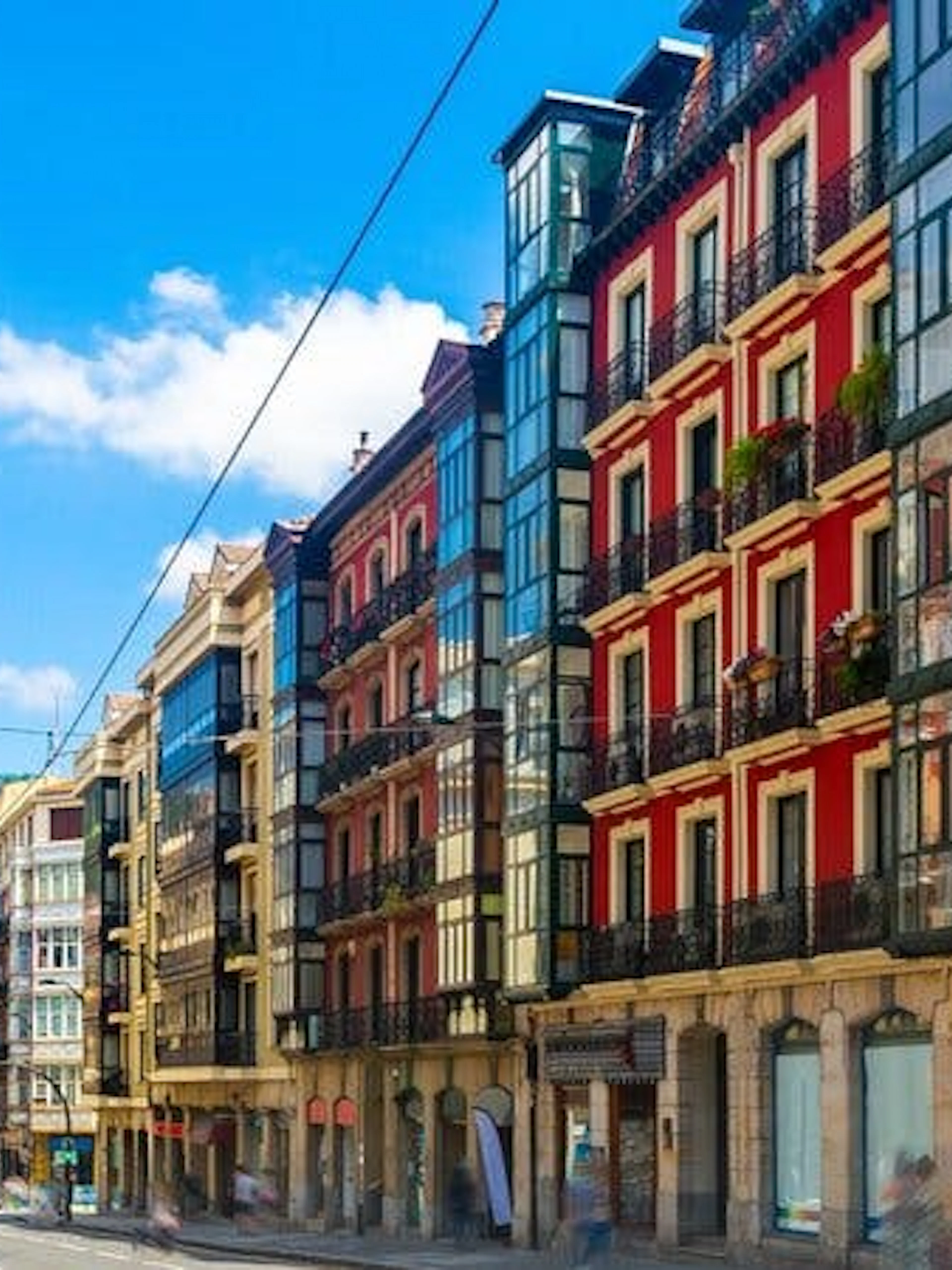 Colorful buildings along a street in Bilbao, Spain, part of a self-guided walking tour.