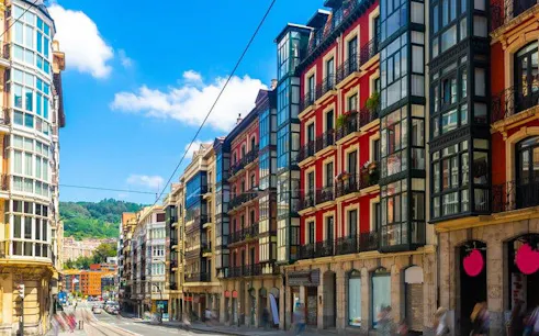 Colorful buildings along a street in Bilbao, Spain, part of a self-guided walking tour.