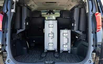 Luggage in the trunk of a private charter vehicle for Osaka airport or port transfer.