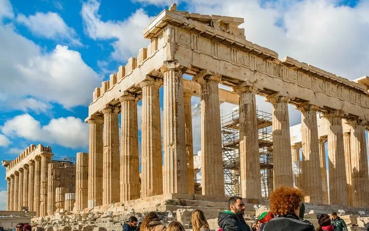 Parthenon in Athens with tourists exploring ancient ruins on a self-guided walking tour.