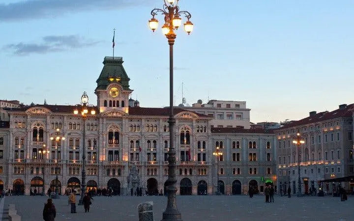 Piazza Unità d'Italia in Trieste at dusk during a self-guided walking tour.