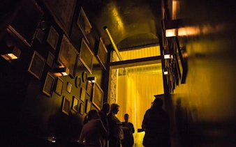 Guests gather in dimly lit hallway at Lisbon's historic Roman theatre venue.
