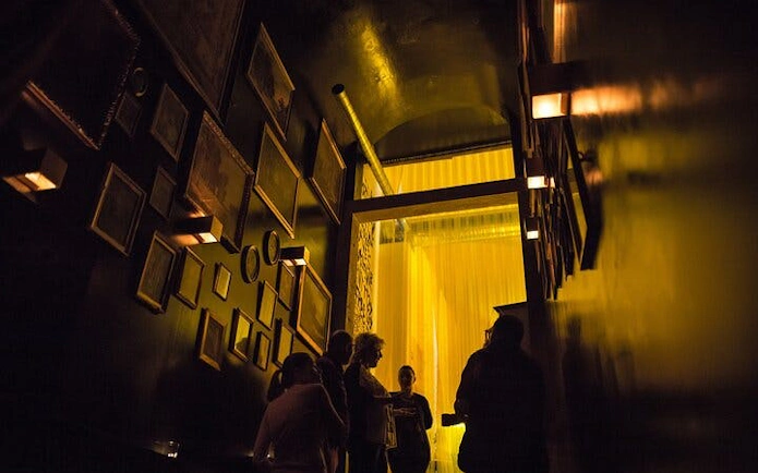 Guests gather in dimly lit hallway at Lisbon's historic Roman theatre venue.