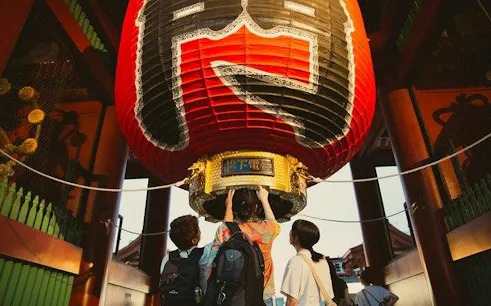 Visitors admire the giant red lantern at Sensoji Temple in Asakusa, Tokyo.