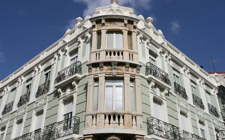 Elegant historic building facade in León, Spain, featured on self-guided walking tour app.