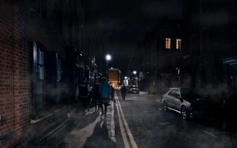 Group walking on a foggy street during York haunted history tour at night.