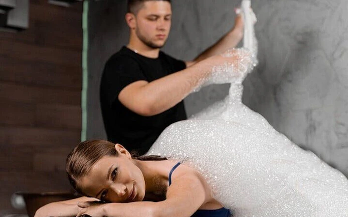 Traditional Moroccan hammam massage with bubbles in Marrakech spa.