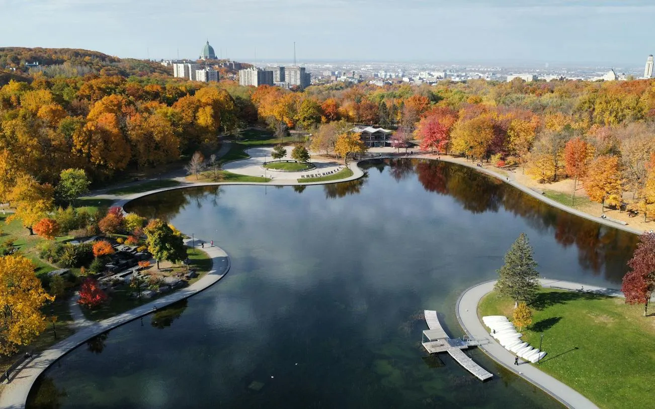 Aerial view of Beaver Lake in Mount Royal Park, Montreal, surrounded by autumn trees.