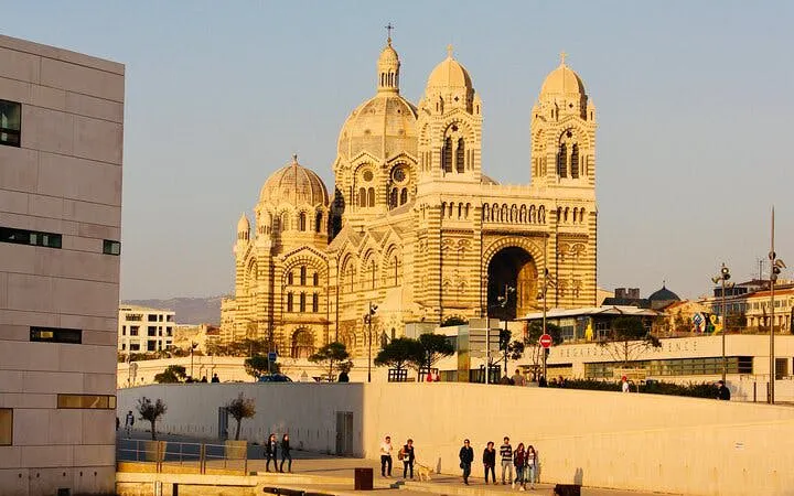 Marseille Cathedral with people exploring nearby, part of self-guided city game.