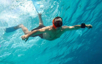 Snorkeler exploring clear waters during a private speedboat tour, Sharm El Sheikh coast.