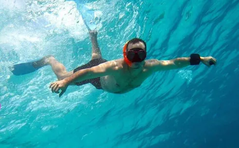 Snorkeler exploring clear waters during a private speedboat tour, Sharm El Sheikh coast.