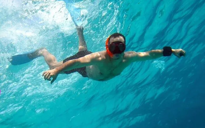 Snorkeler exploring clear waters during a private speedboat tour, Sharm El Sheikh coast.