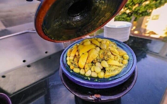 Moroccan tagine dish with lemons and olives during Essaouira cooking class.