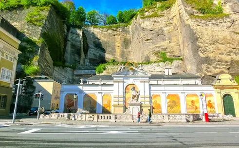 Salzburg's Horse Pond with historic murals and cliff backdrop on self-guided music history tour.