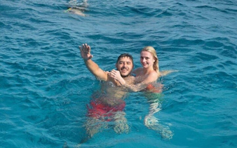 Couple swimming in the Red Sea during Sharm El Sheikh speedboat tour.