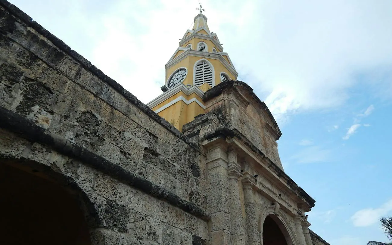 Clock tower at the entrance of Cartagena Walled City, part of a self-guided audio walking tour.