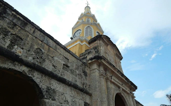 Clock tower at the entrance of Cartagena Walled City, part of a self-guided audio walking tour.