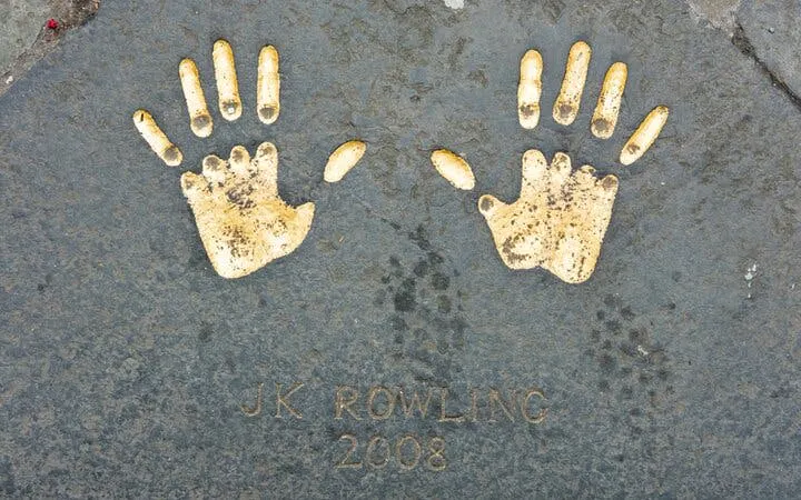 Handprints on Edinburgh pavement from 2008, part of city exploration game.