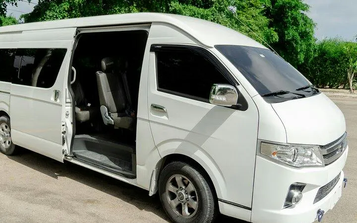 White van for Punta Cana private airport transfer with open door and seating visible.