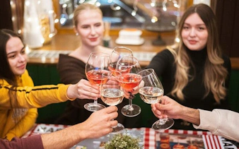 Group toasting with wine glasses on Budapest food tour.