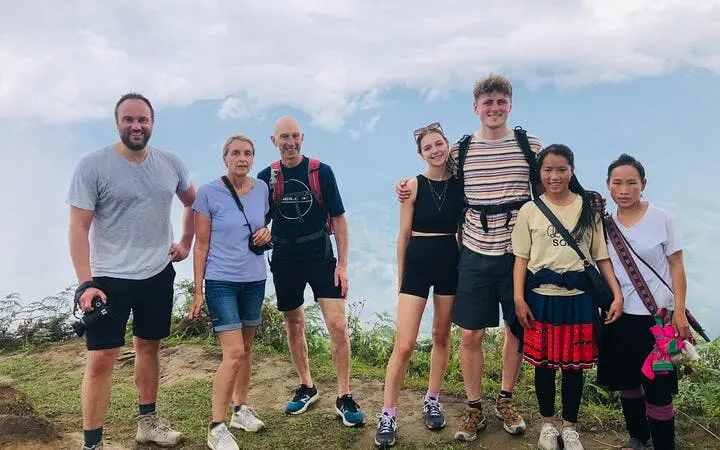 Group of trekkers with local Red Dao guides in Ta Phin Village, Sapa, Vietnam.