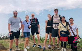 Group of trekkers with local Red Dao guides in Ta Phin Village, Sapa, Vietnam.