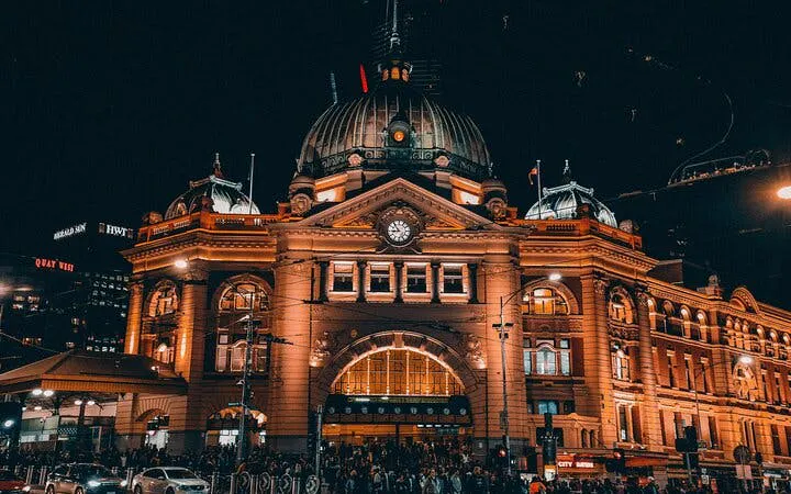 Flinders Street Station illuminated at night, part of Ghosts of Melbourne city exploration game.
