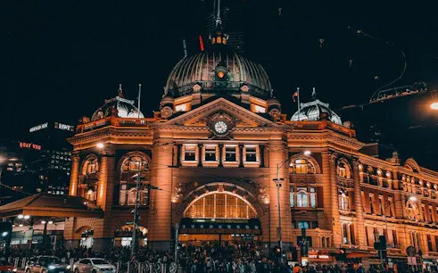 Flinders Street Station illuminated at night, part of Ghosts of Melbourne city exploration game.