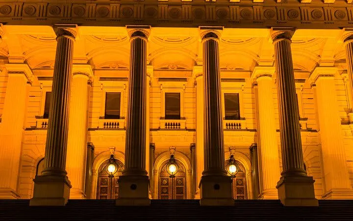 Parliament House in Melbourne illuminated at night, part of the Ghosts of Melbourne tour.