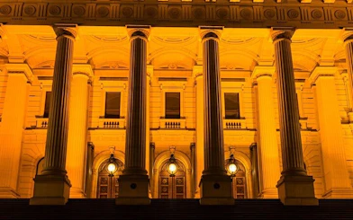 Parliament House in Melbourne illuminated at night, part of the Ghosts of Melbourne tour.