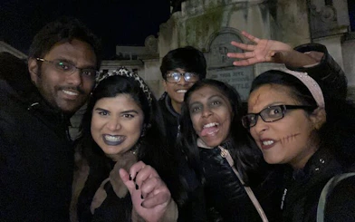 Group enjoying Haunted Liverpool city exploration game at night in a cemetery.