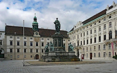 Hofburg Palace courtyard with Emperor Franz I statue, Vienna, related to the Great Plague exploration game.
