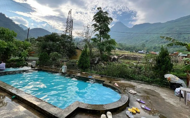 Poolside view of Sapa mountains during guided motorbike village tour, Cat Cat Village, Vietnam.